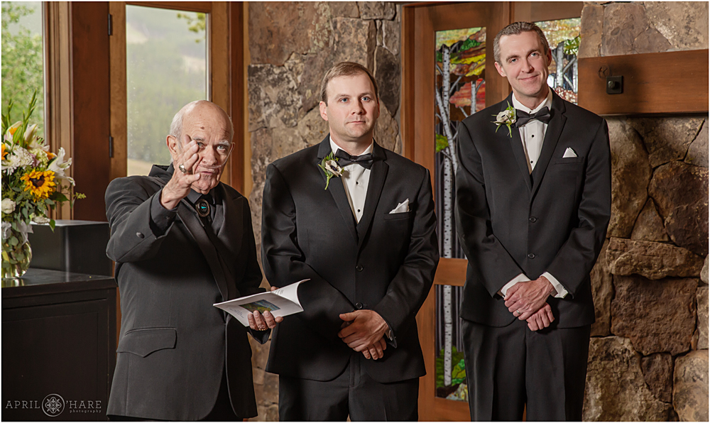 Groom watches his bride walk down the aisle at their private home wedding in Breckenridge Colorado