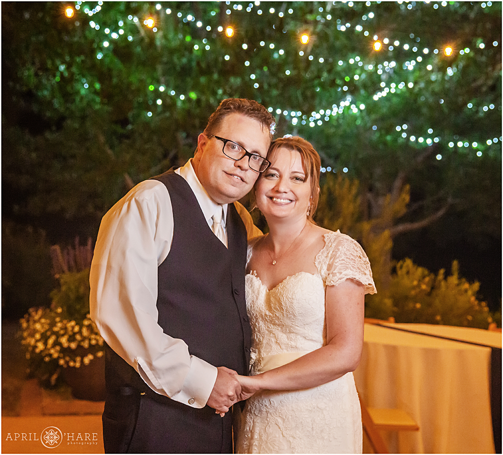 Sweet end of the night wedding portrait with twinkle light backdrop at Chatfield Farms