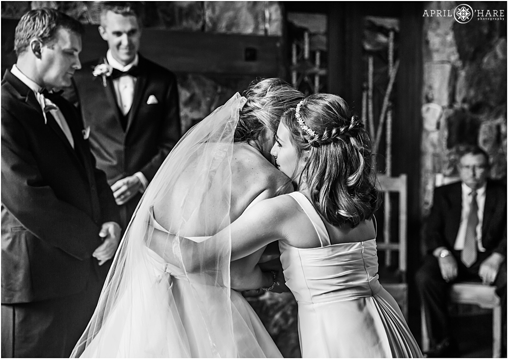 Bride hugs her maid of honor daughter at private home wedding in Breckenridge CO