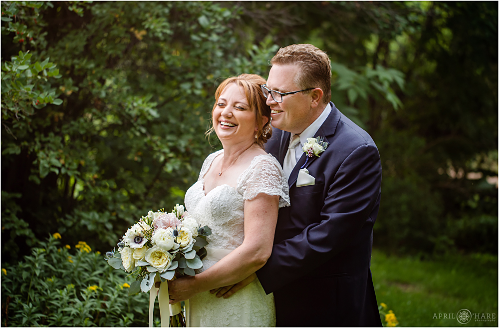 Bride and groom laugh together on their Littleton Garden wedding day at Chatfield Farms