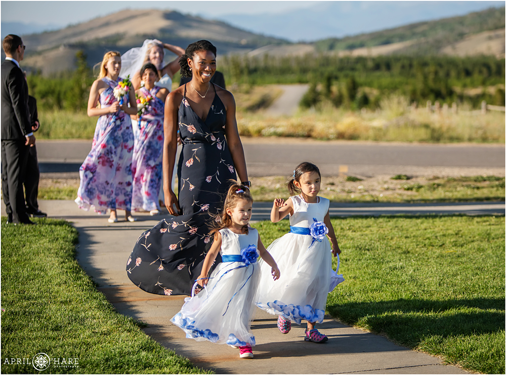 Flower girls in white dress with blue flowers at YMCA of the Rockies Snow Mountain Ranch in Granby