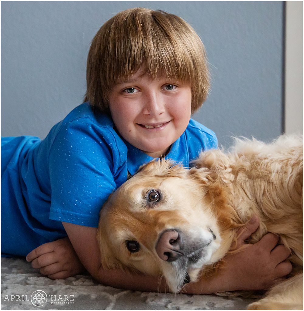 A young boy with his sweet lovebug dog at home