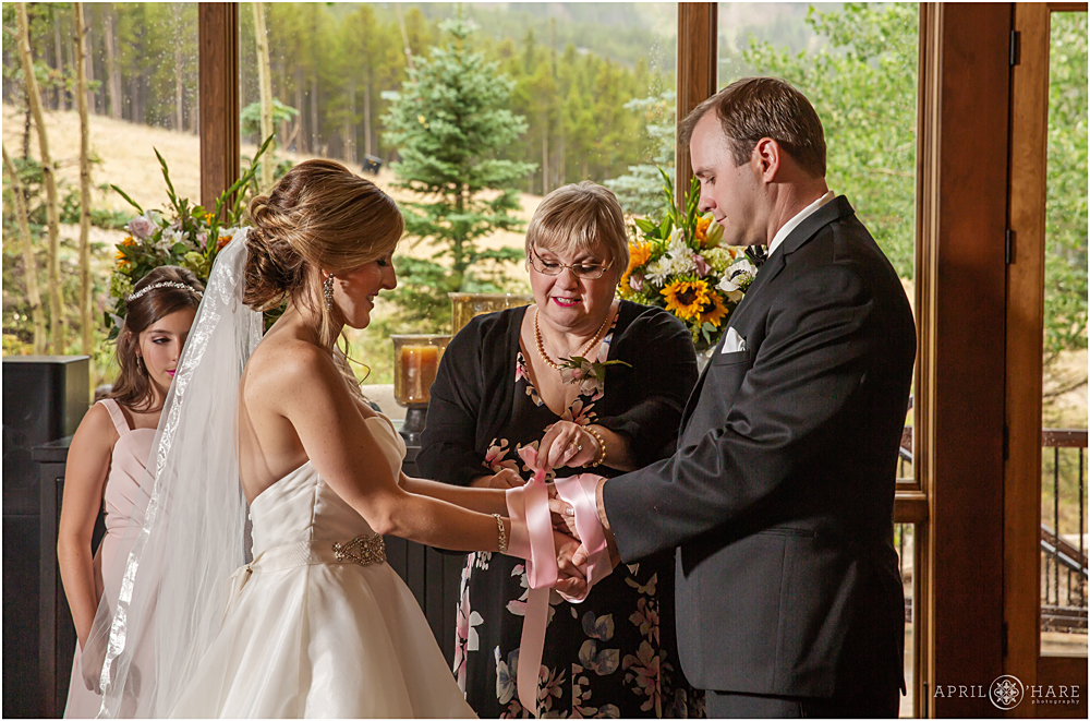 Hand tying ceremony at intimate private home wedding in Breckenridge CO