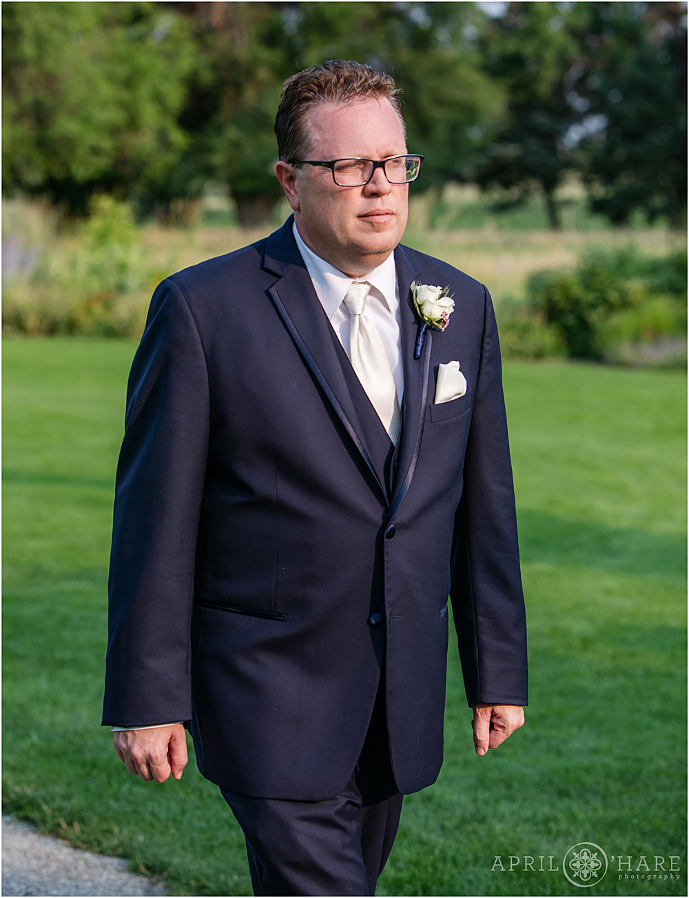Groom walks down the aisle at his Littleton Garden Wedding