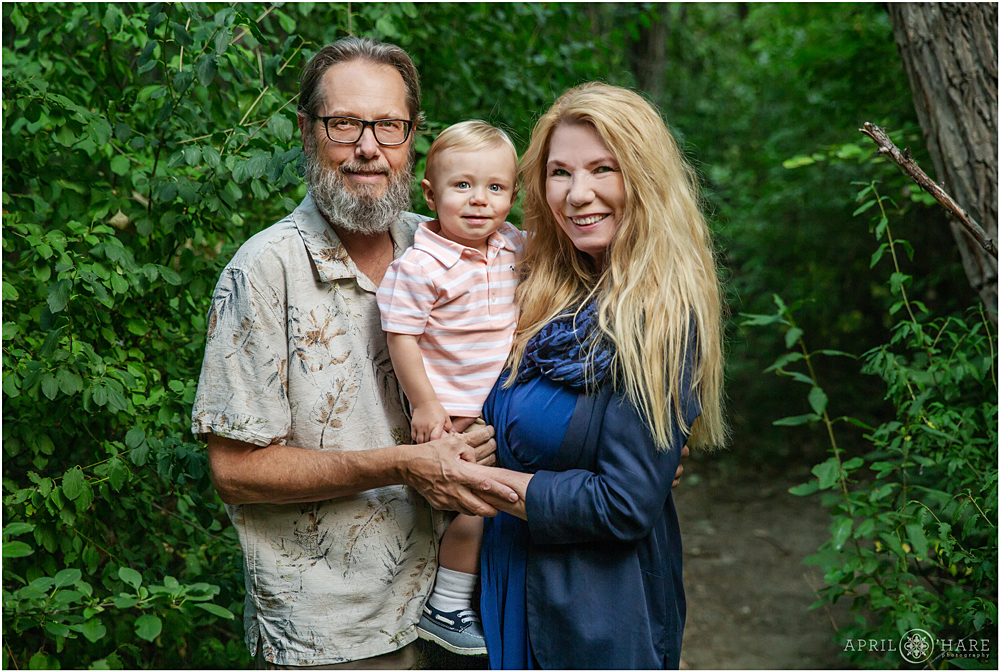 Grandparents hold their grandson at Cherry Creek Trail in East Denver Family Photos