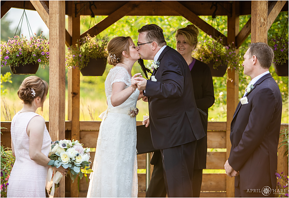 First Kiss at Denver Botanic Gardens Chatfield Farms Wedding Ceremony