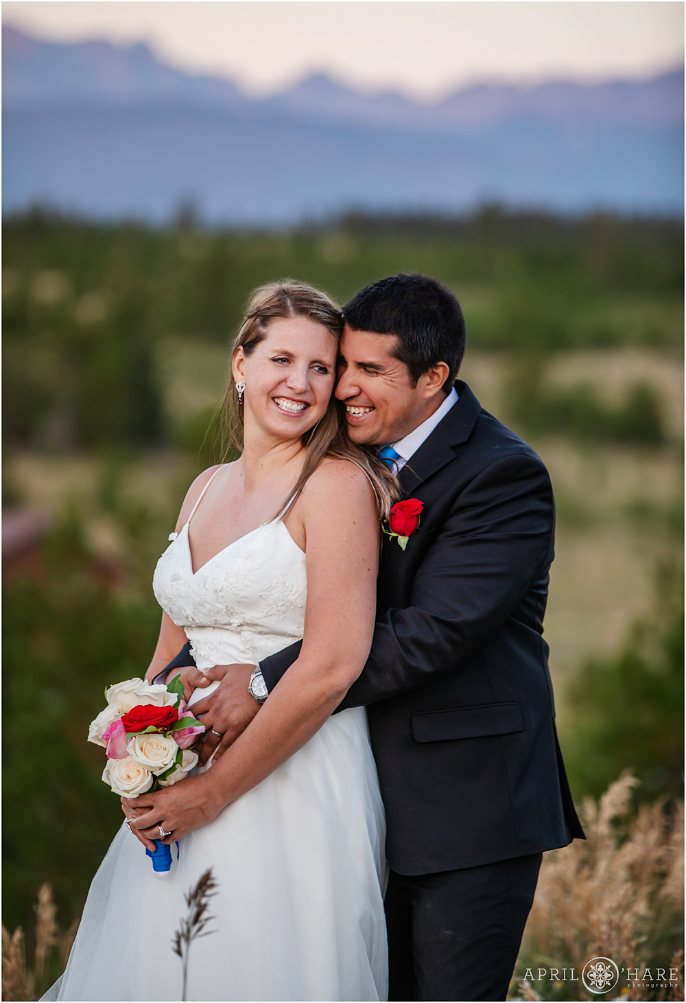 Sweet moment of bride and groom laughing together in Granby Colorado