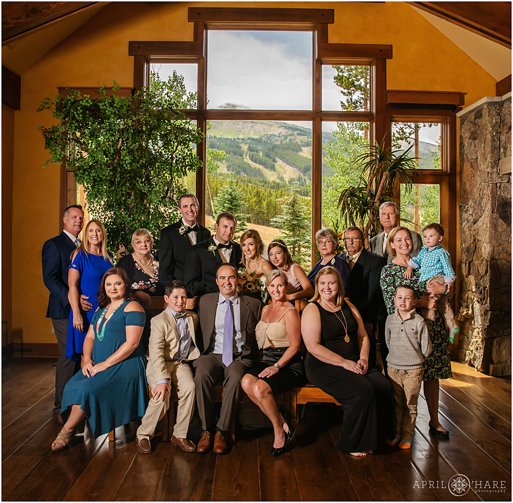 Extended family portrait in front of huge windows at private home in Breckenridge