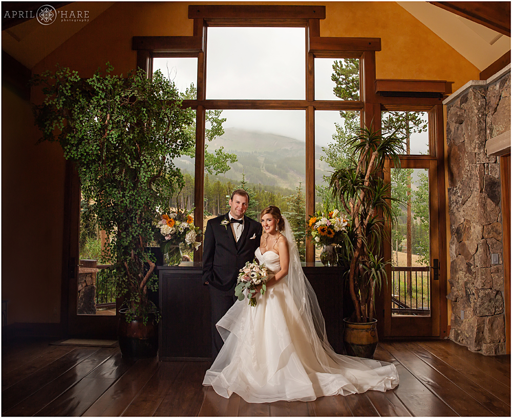 Classic bride and groom portrait in front of huge windows in Breckenridge Colorado