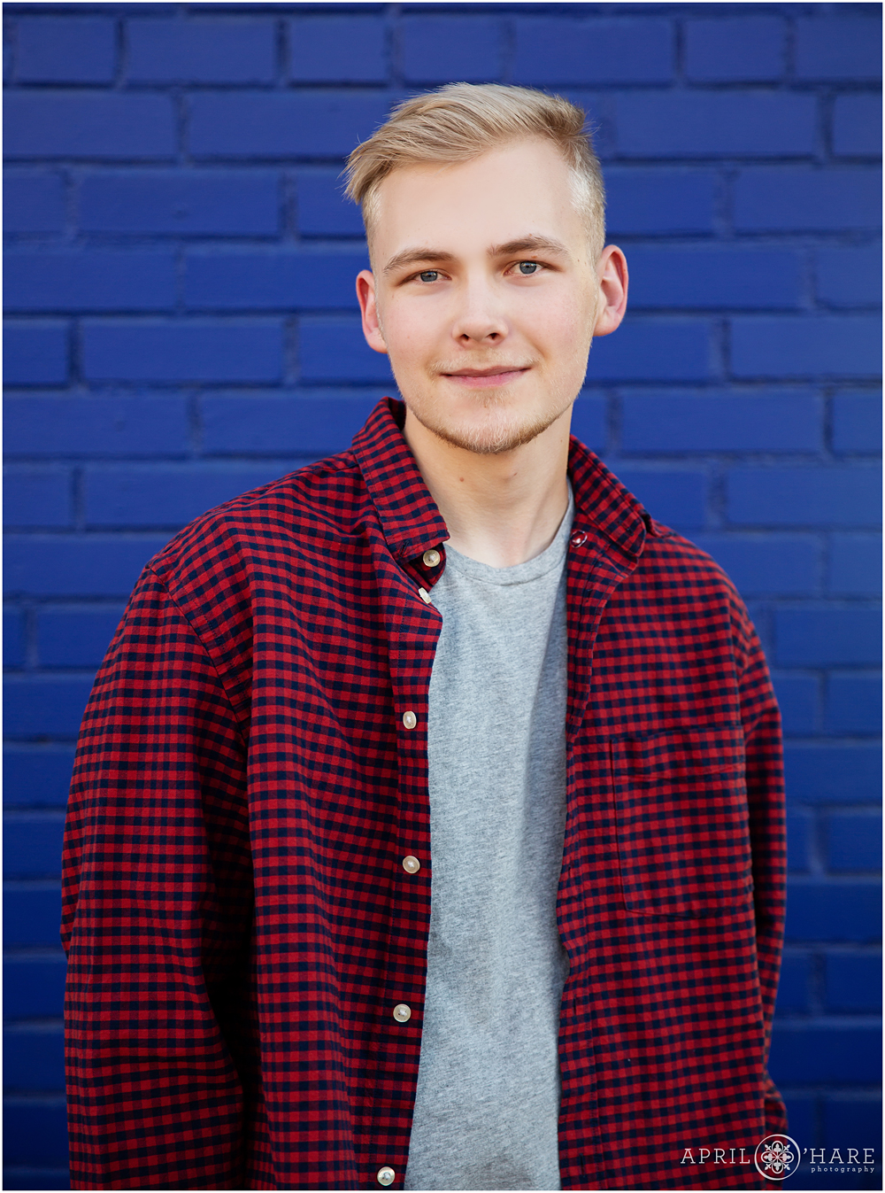 Classic High School Senior Boy Photo with Blue Brick Wall Backdrop