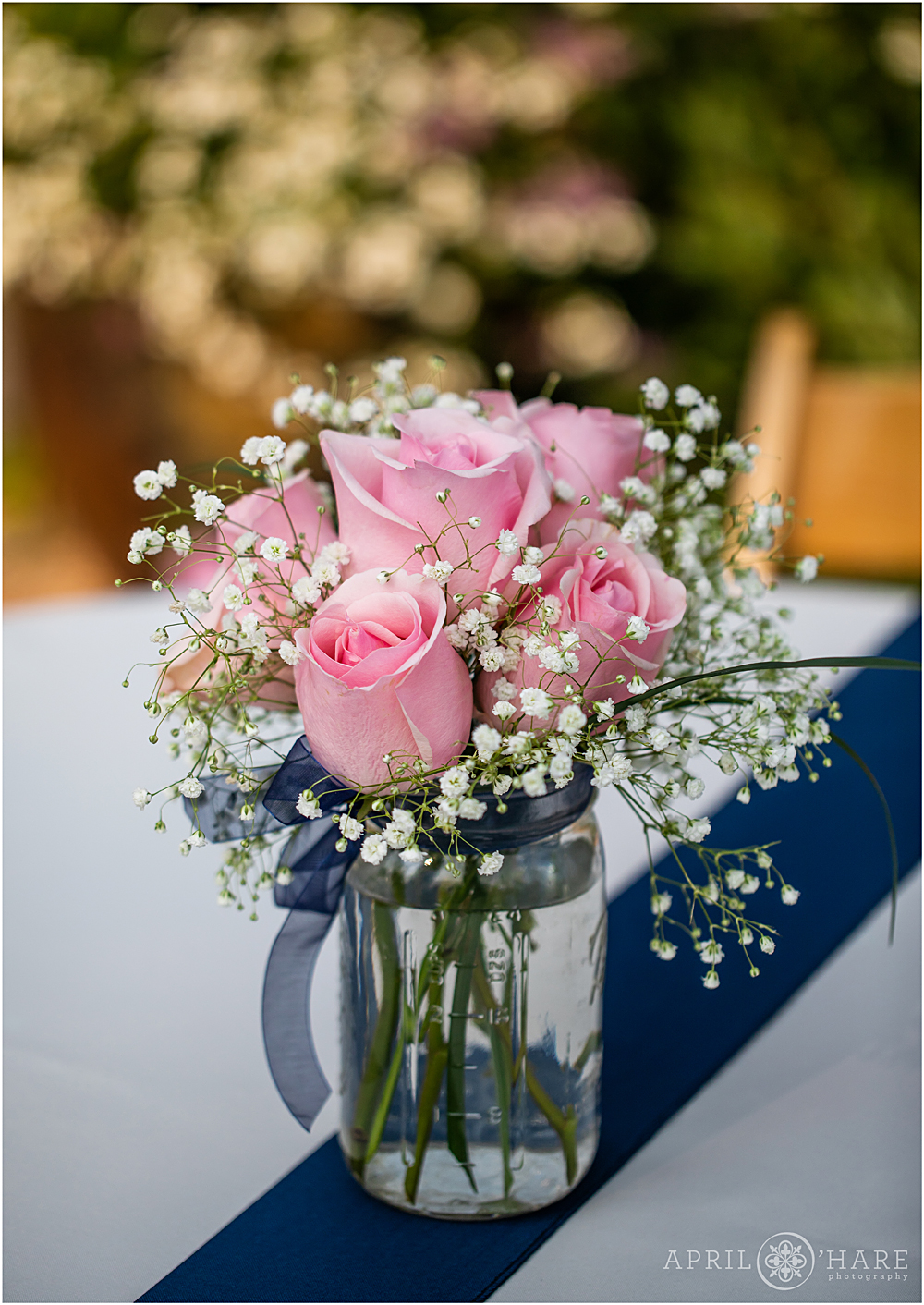 Pink roses and baby's breath table centerpieces at Chatfield Farms