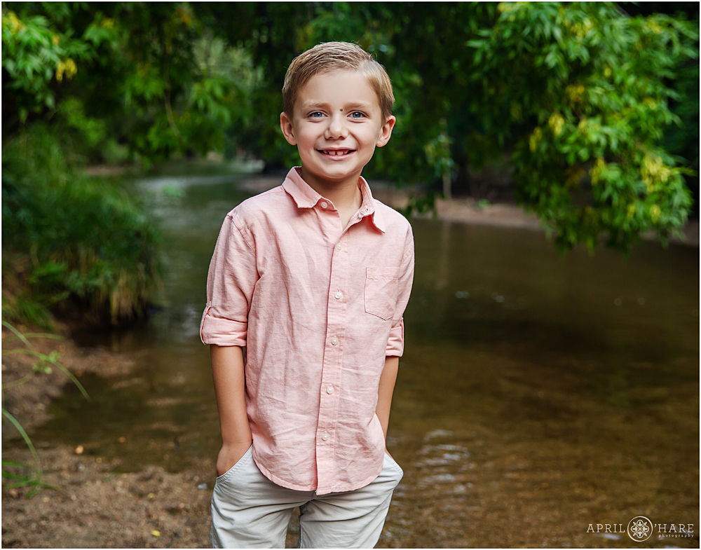 Happy boy at his family portraits at Cherry Creek Trail in Denver CO