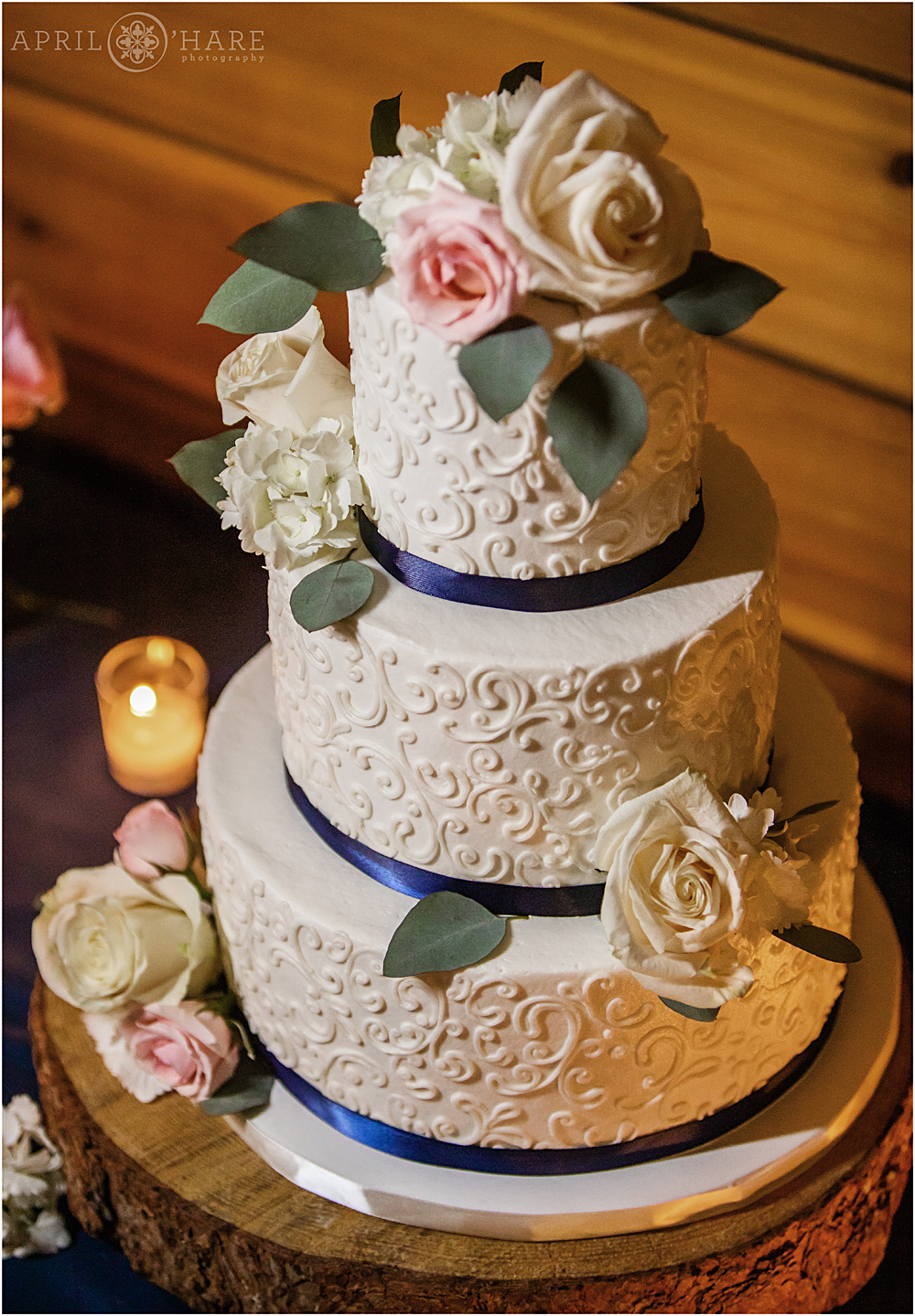 Three tiered white wedding cake with pink roses from Kelly Kakes