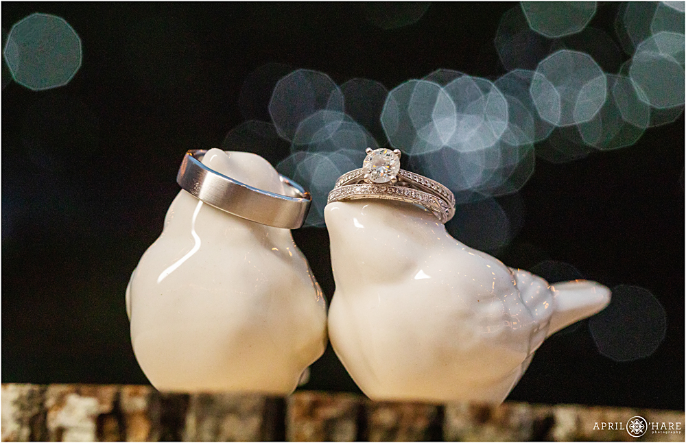 Detail photos of wedding rings with twinkle light backdrop