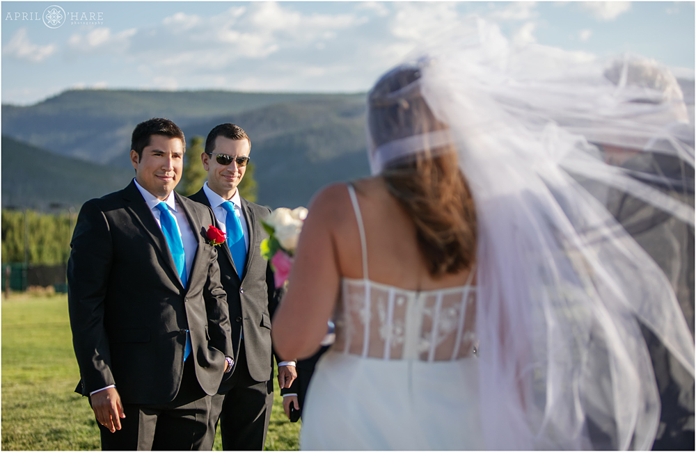 Bride approaches groom at outdoor Colorado wedding at Snow Mountain Ranch in Granby