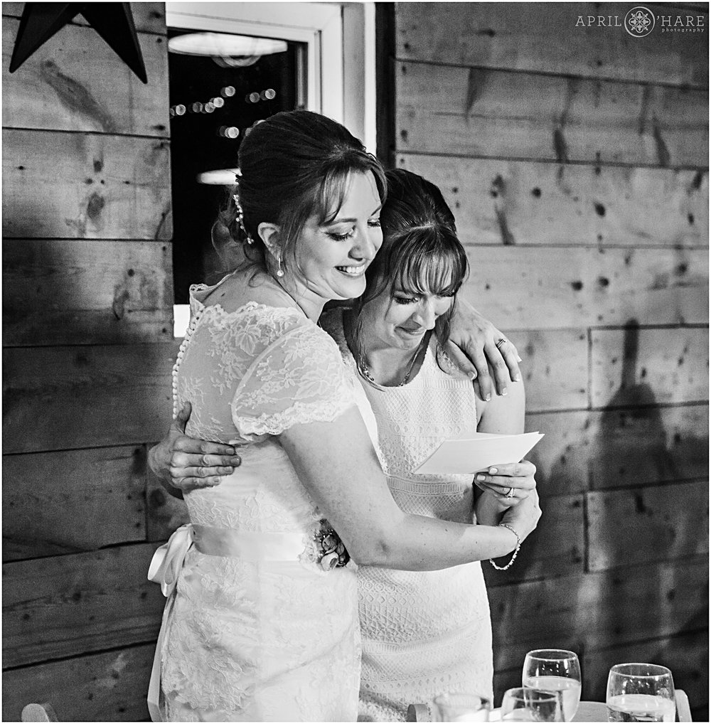 Sisters hug on a wedding day at Chatfield Farms
