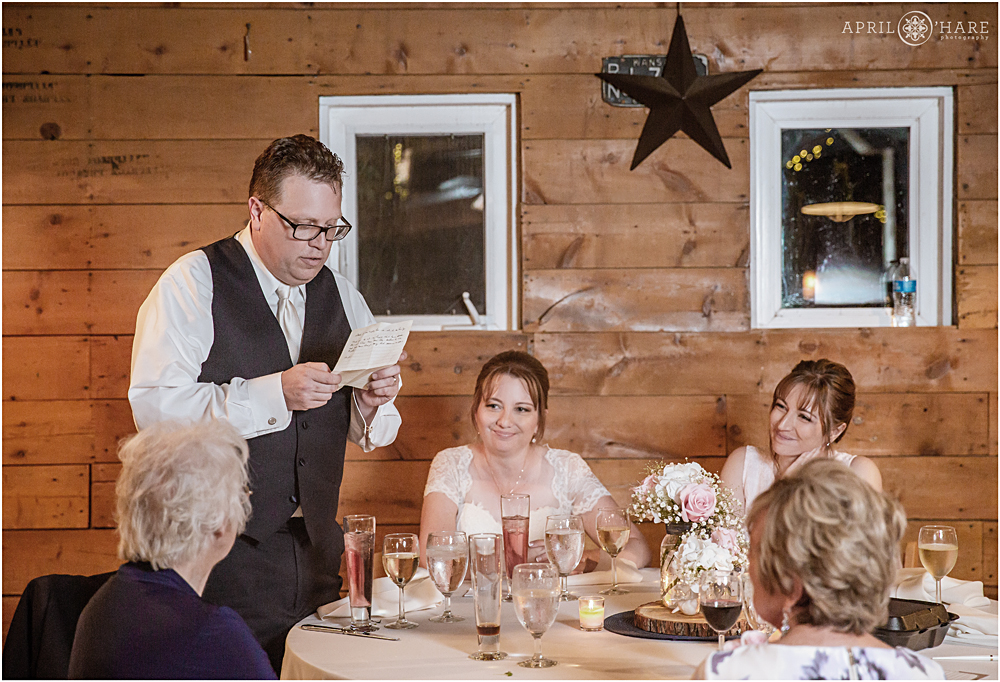Wedding day speech inside rustic barn at Chatfield Farms
