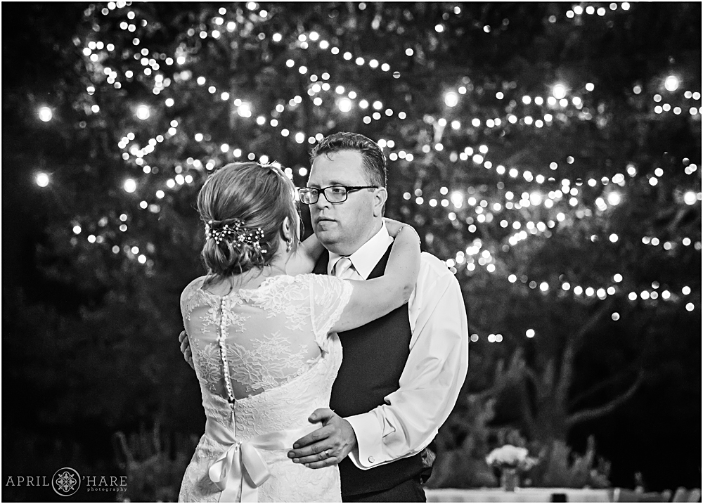 B&W wedding photo under the twinkle lights at Denver Botanic Gardens Chatfield Farms