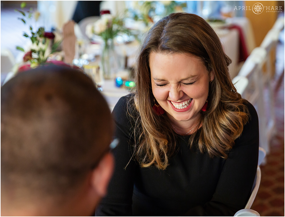 Guests laugh during dinner at A-Basin Destination wedding in Colorado