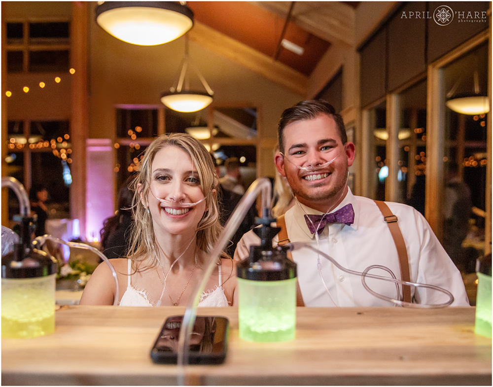 Bride and groom use the oxygen bar at their Colorado mountain wedding