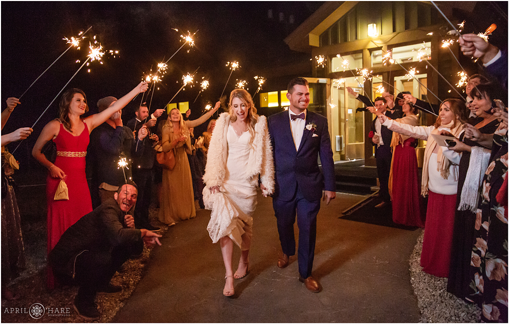 Bride and groom walk down the sparkler aisle for their Grand exit at the end of their wedding reception