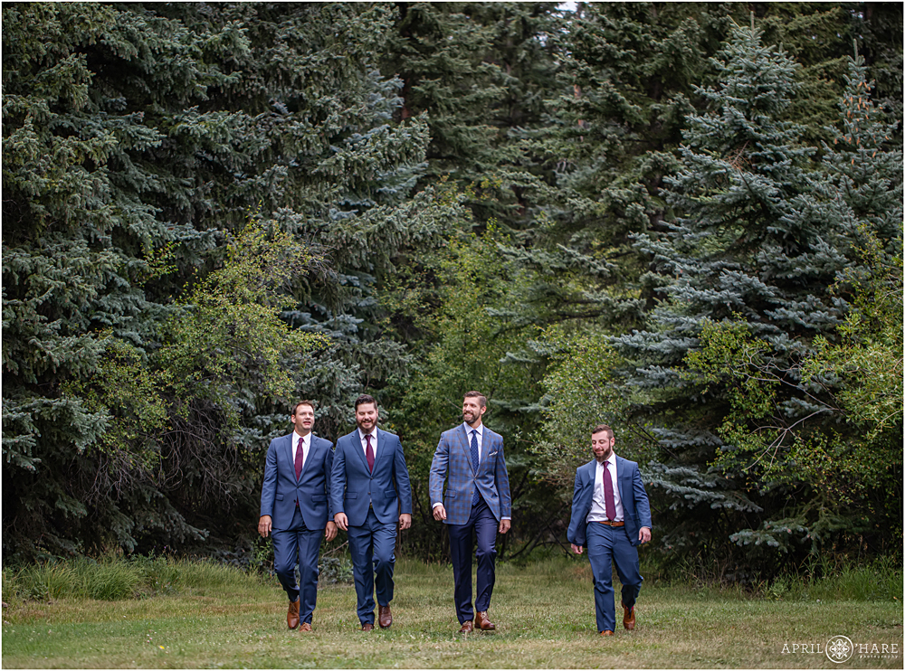 Groom with his friends emerge from the forest at Wedgewood Weddings Mountain View Ranch