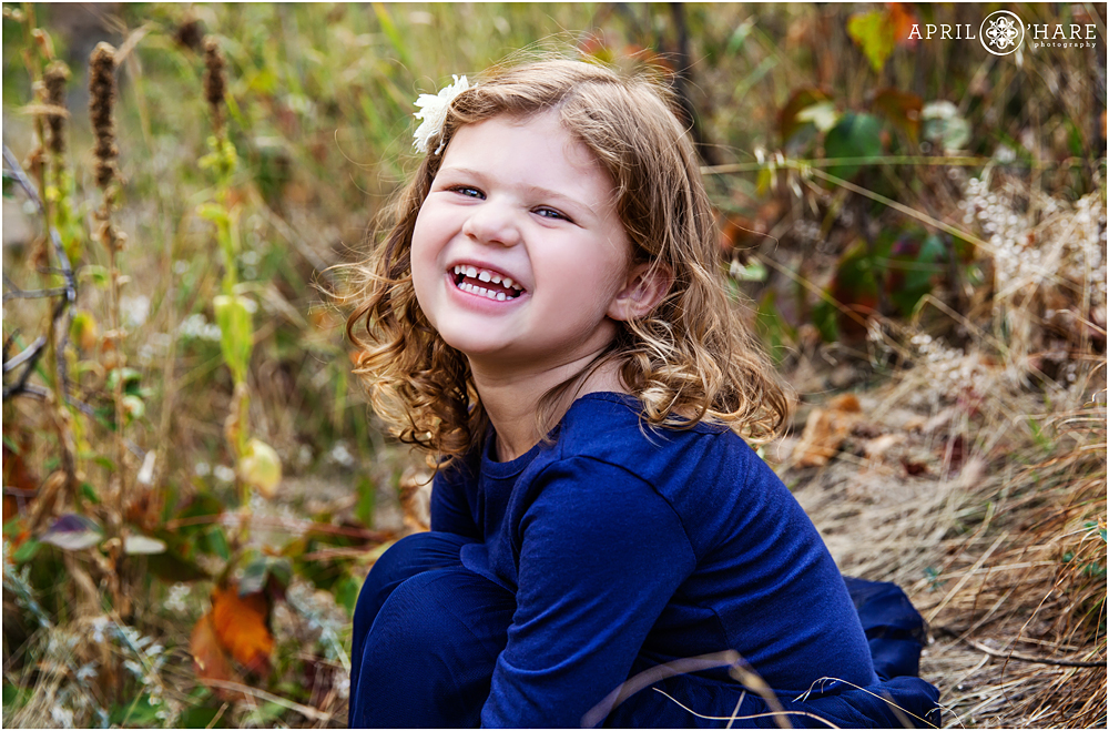 Sweet laughing little girl at her fall family photography session in Golden Colorado
