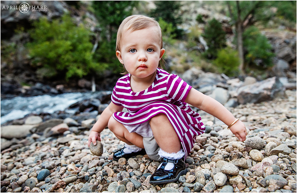 Serious toddler girl next to Clear Creek at First Tunnel Walk in Colorado