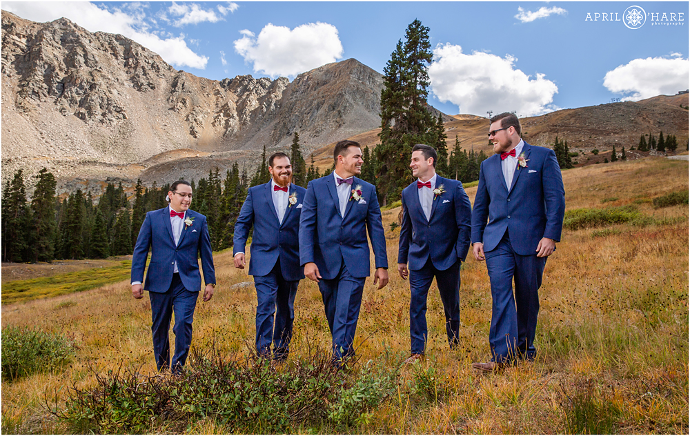 Groom with his friends at his autumn wedding in Colorado mountains