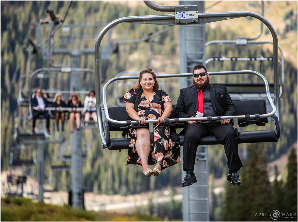 Wedding guests ride the Black Mountain Express chairlift at Arapahoe Basin Ski Resort in CO