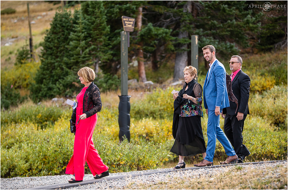 Wedding guests walk to the ceremony site after exiting the chairlift at a Destination wedding in Colorado