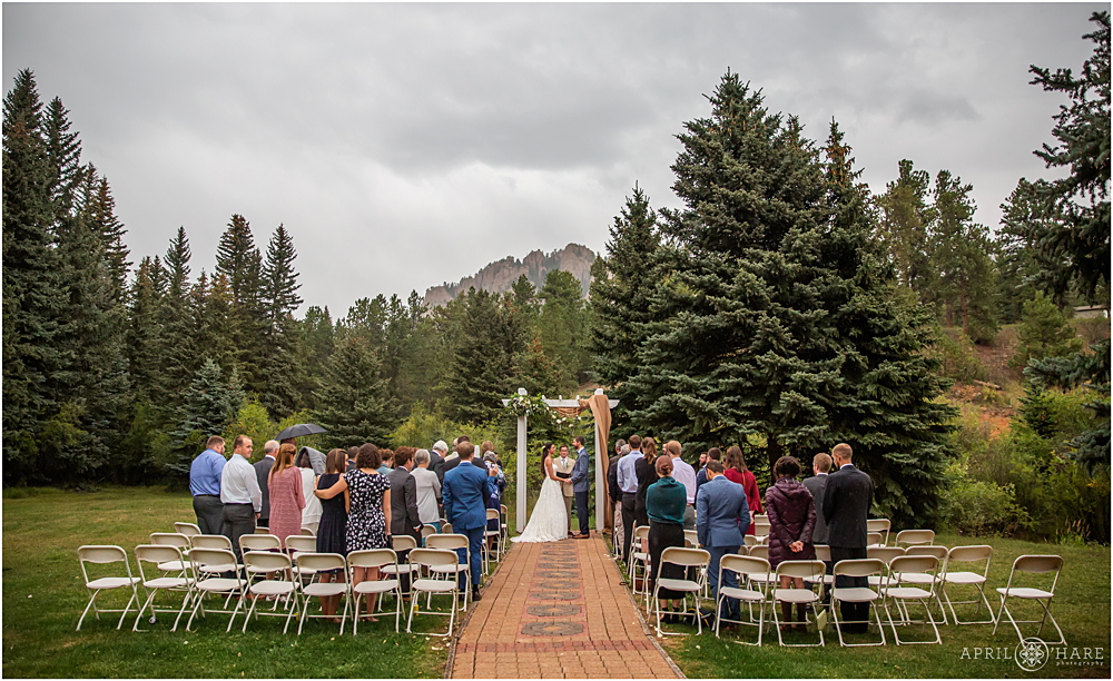 Outdoor wedding ceremony with a Romantic Rainy Wedding