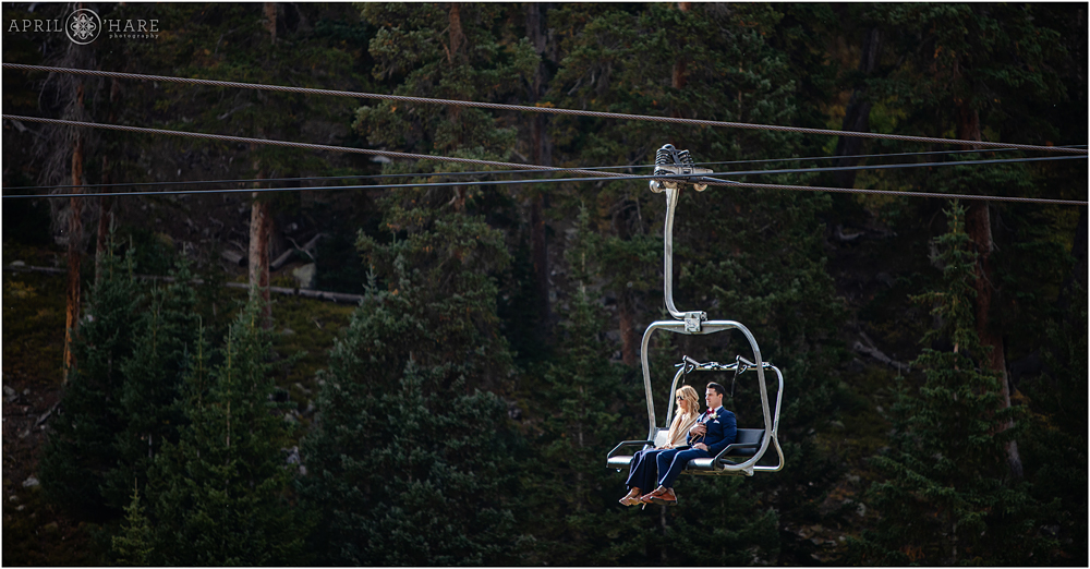 A beautiful photo of wedding guests riding the chairlift at a destination wedding in Colorado
