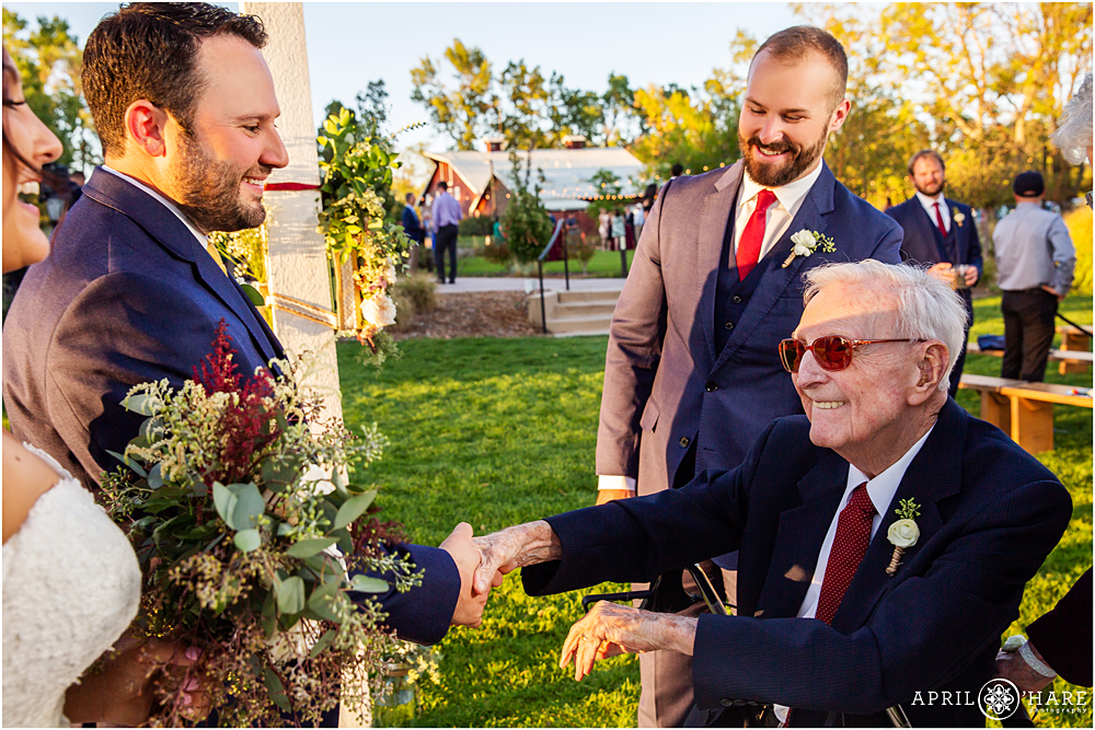 Shaking hands with Grandpa at a Colorado wedding