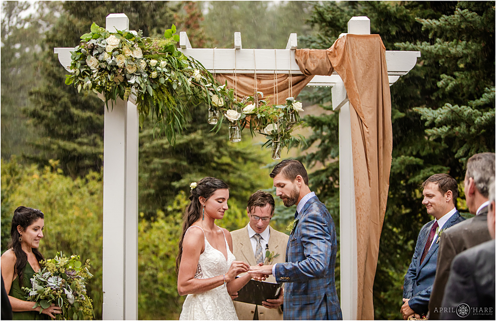 Ring exchange in a beautiful outdoor wedding in CO at Wedgewood Weddings Mountain View Ranch