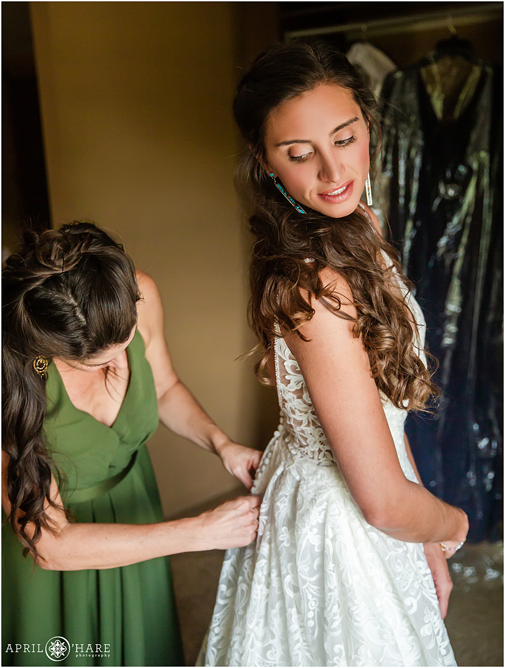 Maid of honor helps her friend with her dress at Wedgewood Weddings Mountain View Ranch