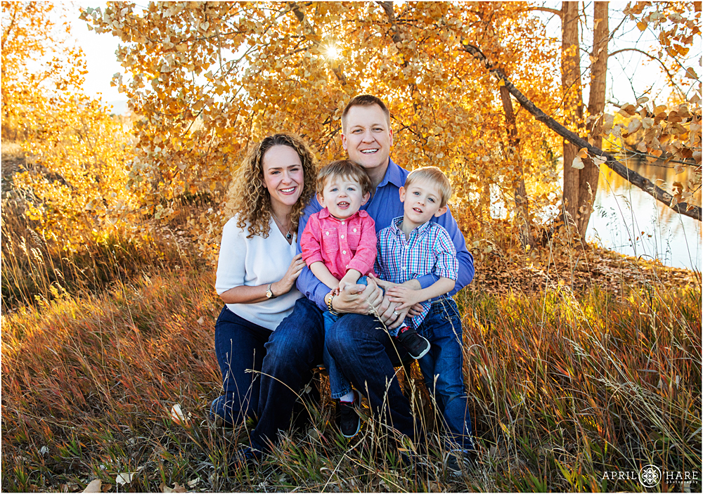 Cute family of 4 in the fall color at Kountz Lake in Lakewood Colorado