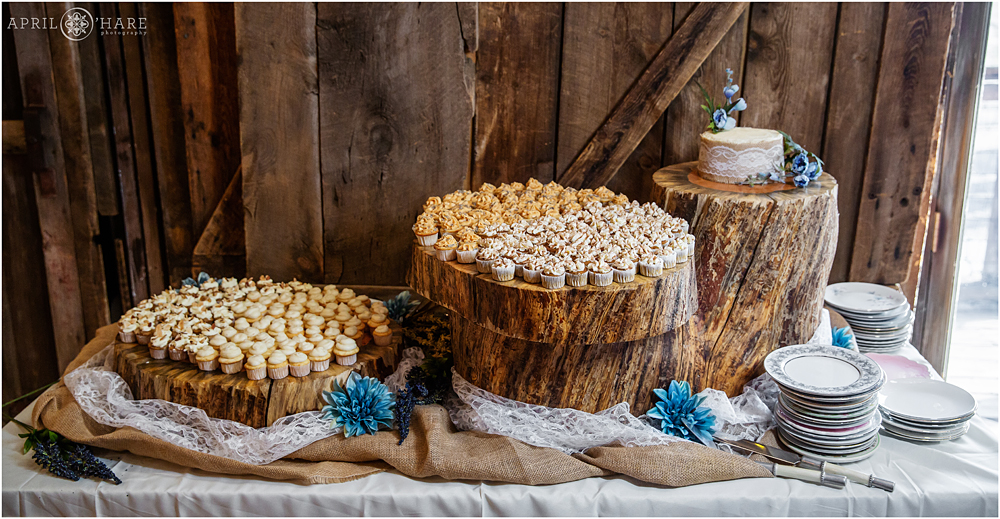 Mini cupcake display for a rustic wedding reception in a barn