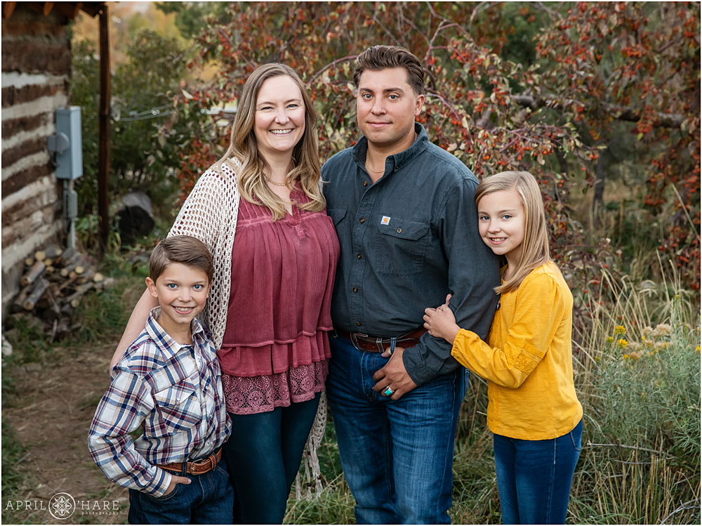 Family of four pose for a fall color photo in Golden Colorado
