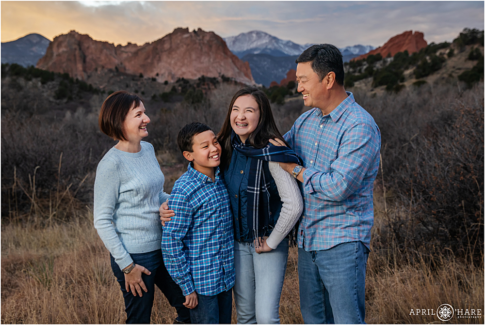 A family laughs at their family photo session at Garden of the Gods in Colorado Springs