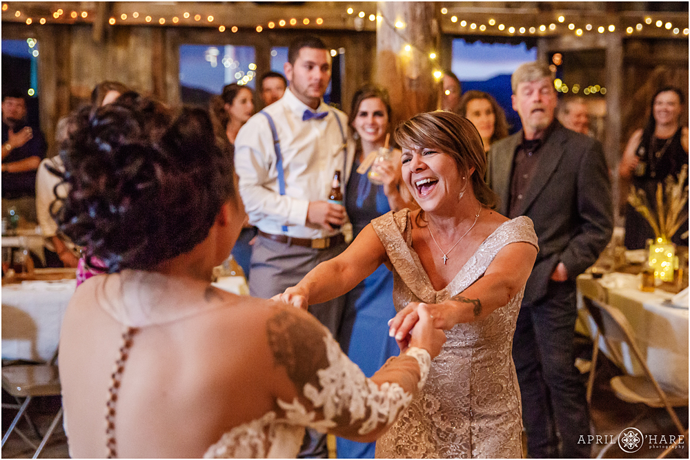Mother of the bride dances with bride on her wedding day in Colorado