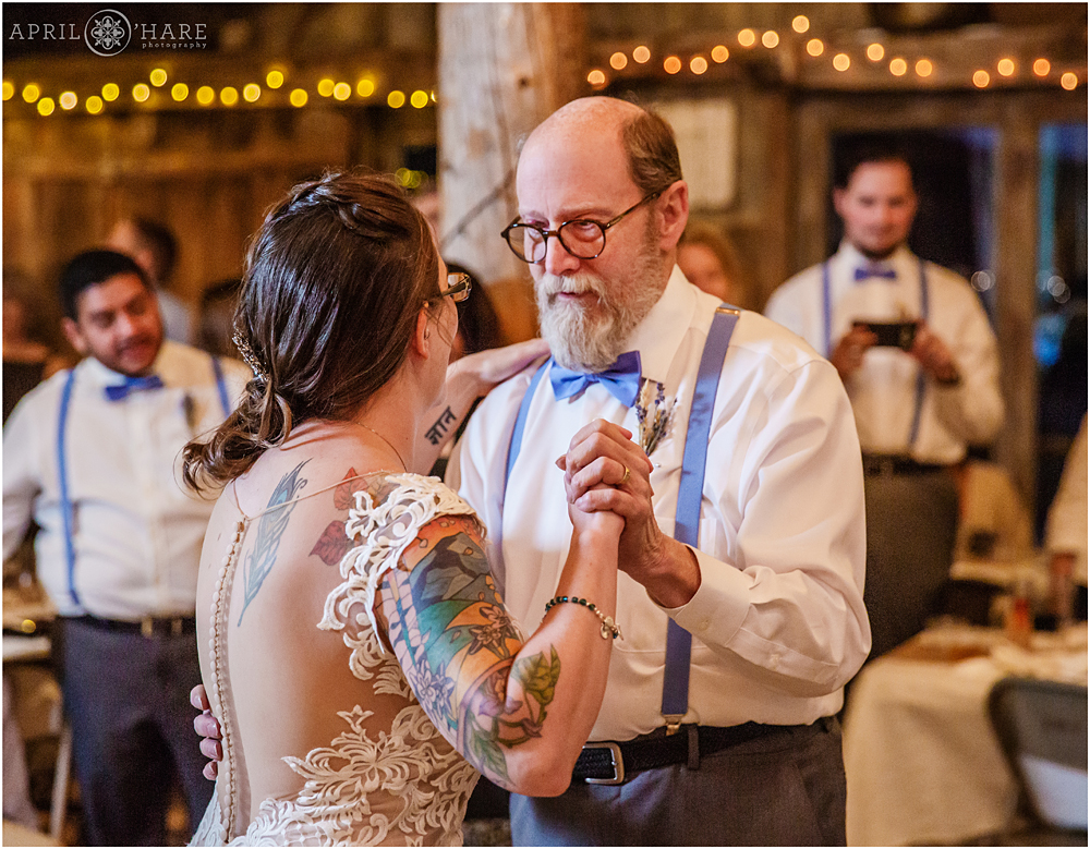Father of the bride dances with bride on her wedding day in Colorado