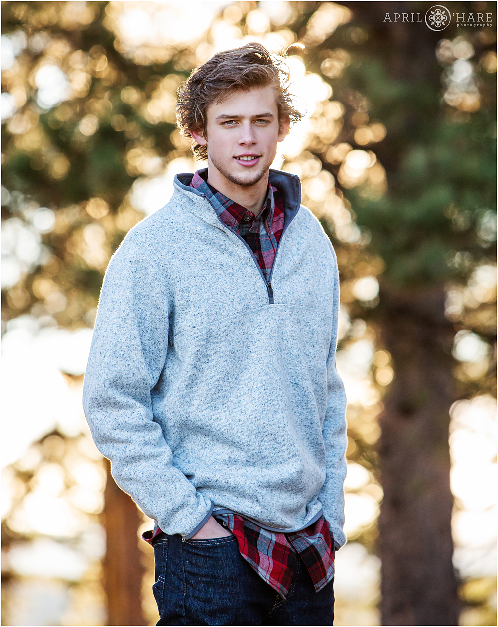 Backlit forest high school senior photo at Mount Falcon in Colorado