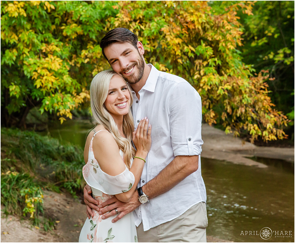Beautiful couple portrait during fall color season at Cherry Creek Trail in Denver Colorado