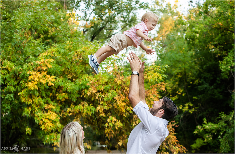Dad throws his one year old up in the air Denver Photographer