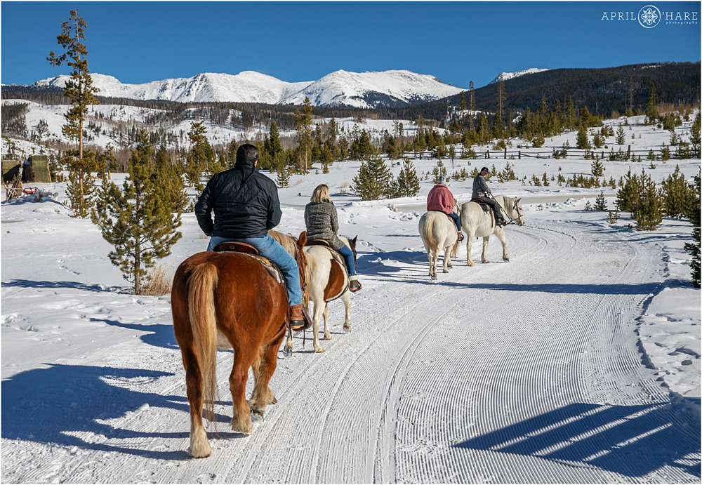 Family horseback ride during winter at Devil's Thumb Ranch