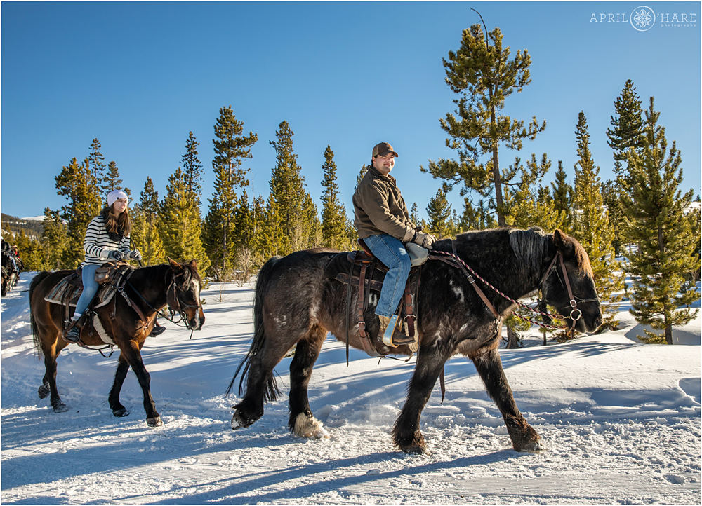 Horseback ride winter proposal photography at Devil's Thumb Ranch in Colorado