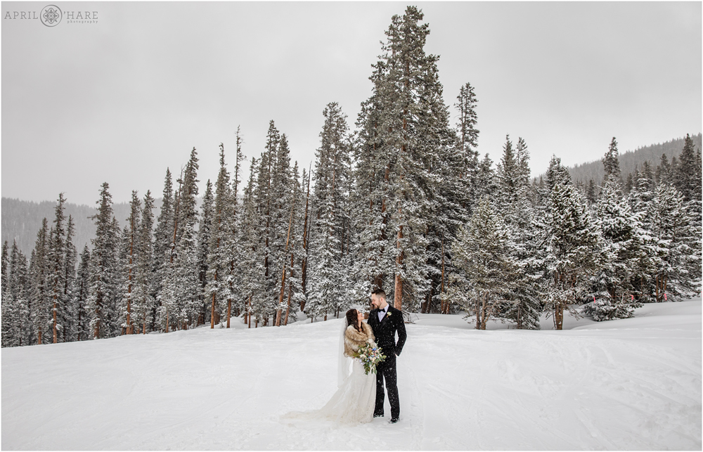 Colorado Destination Wedding during winter at Keystone Resort with snow covered tree backdrop