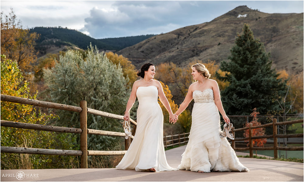 Lesbian brides in love walk together on their Colorado wedidng day