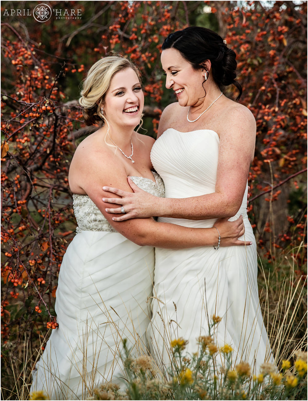 Sweet same sex couple laugh together on their wedding day in Colorado